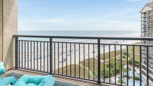 A balcony with a view of a beach and a pool area. - Amazing 1Bedroom Unit with Amazing Oceanfront View (North Myrtle Beach)