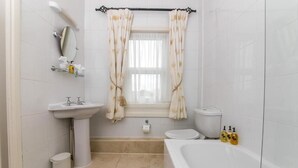 A bathroom with a sink, mirror, toilet, bathtub, and a window with curtains. - Superior Double Room in Bath (Bath)