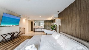 A modern hotel room with a large bed, a bathtub, a TV, and a view of the ocean. - Waterfront Villa | BBQ, Pool, Cinema and Tiki (Palm Beach Gardens)