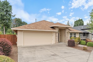 A two-story house with a garage, a brick exterior, and a well-maintained front yard. - 3 Bedroom House in Suburban Retreat (Gresham)