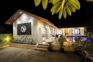 A modern house with a pool, potted plants, and a sign reading 'Sorte Villa.' - Serene Villa by iLiF Hotels (Alibag)