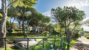 A park with trees, a playground, and a dirt path. - NEREIDS-The Coastal Suite. The sea one breath away from you (Quartu Sant'Elena)