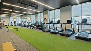 A gym with treadmills, exercise bikes, and a green exercise area. - 501 First Studio Pool  Prime Downtown Miami (Miami)