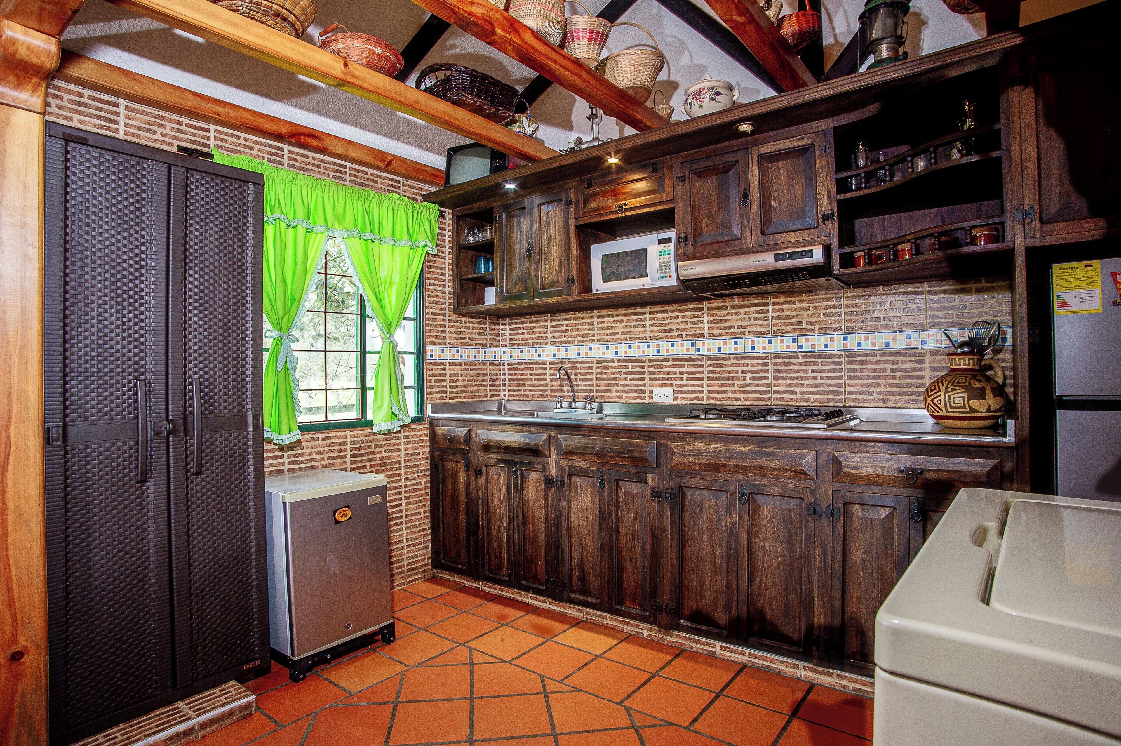 Fridge, microwave, coffee/tea maker, cookware/dishes/utensils