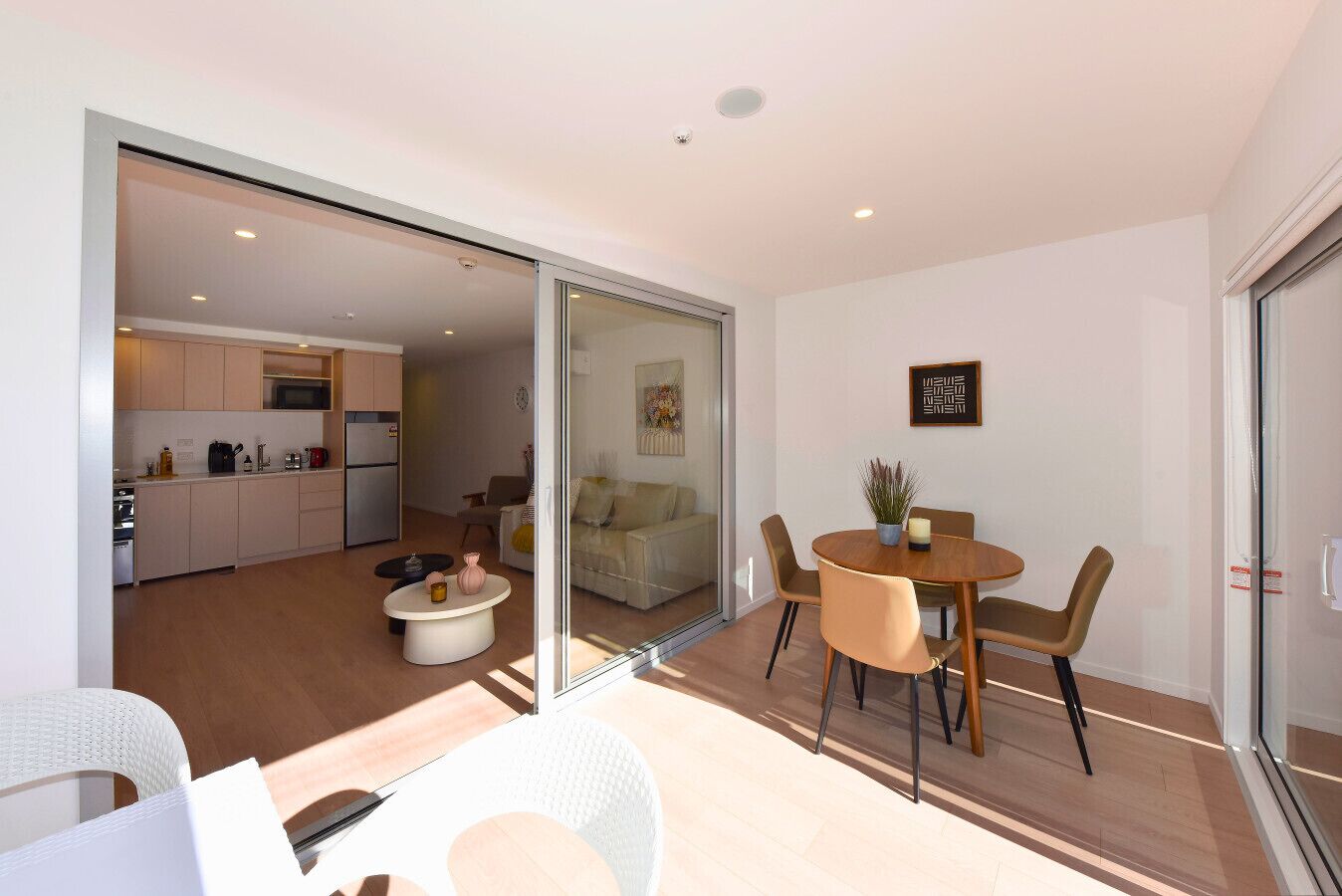 A modern apartment with a kitchen, dining area, and living room.