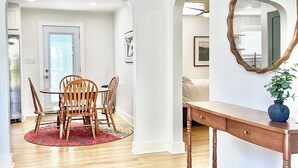 A room with a dining table, chairs, a wooden console table, and a mirror on the wall. - Louisville Home by Kentucky Exposition Center & Churchill Downs (Louisville)