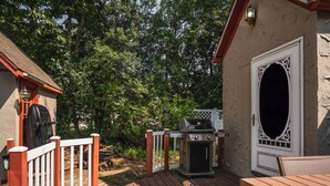 An outdoor deck with a grill and a white door with an ornate design. - Whimsical Historic Getaway Near Golf, Skiing and Wisconsin Southern Lakes (Genoa City)