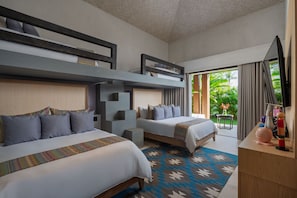 A hotel room with two beds, a bunk bed, a desk, and a view of greenery outside. - Casa De Elementos in Punta Mita (Punta de Mita)