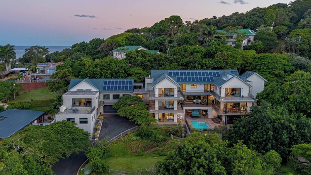 A large, modern house with multiple levels, a swimming pool, and a view of the ocean. - Bay House - Staynest Guesthouse (Ballito)