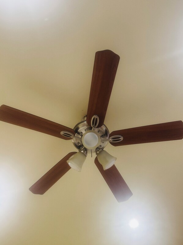 A ceiling fan with five wooden blades and a central light fixture. - Cozy studio in pleasant Norwalk with Kitchen. (Norwalk)