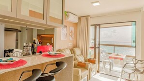 Eine moderne Wohnung mit Küche, Essbereich und einem Balkon mit Blick.