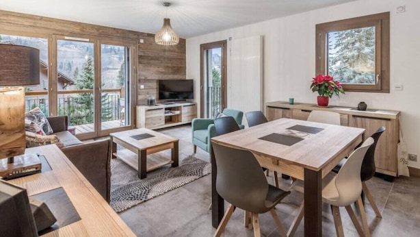 Un interior moderno con comedor, asientos y vistas al exterior.