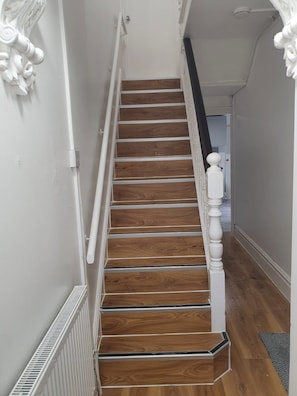 A staircase with wooden steps and white balusters, leading to a landing. - City Centre, P/ Bathroom,room-7, 
City View Place (Cambridge)