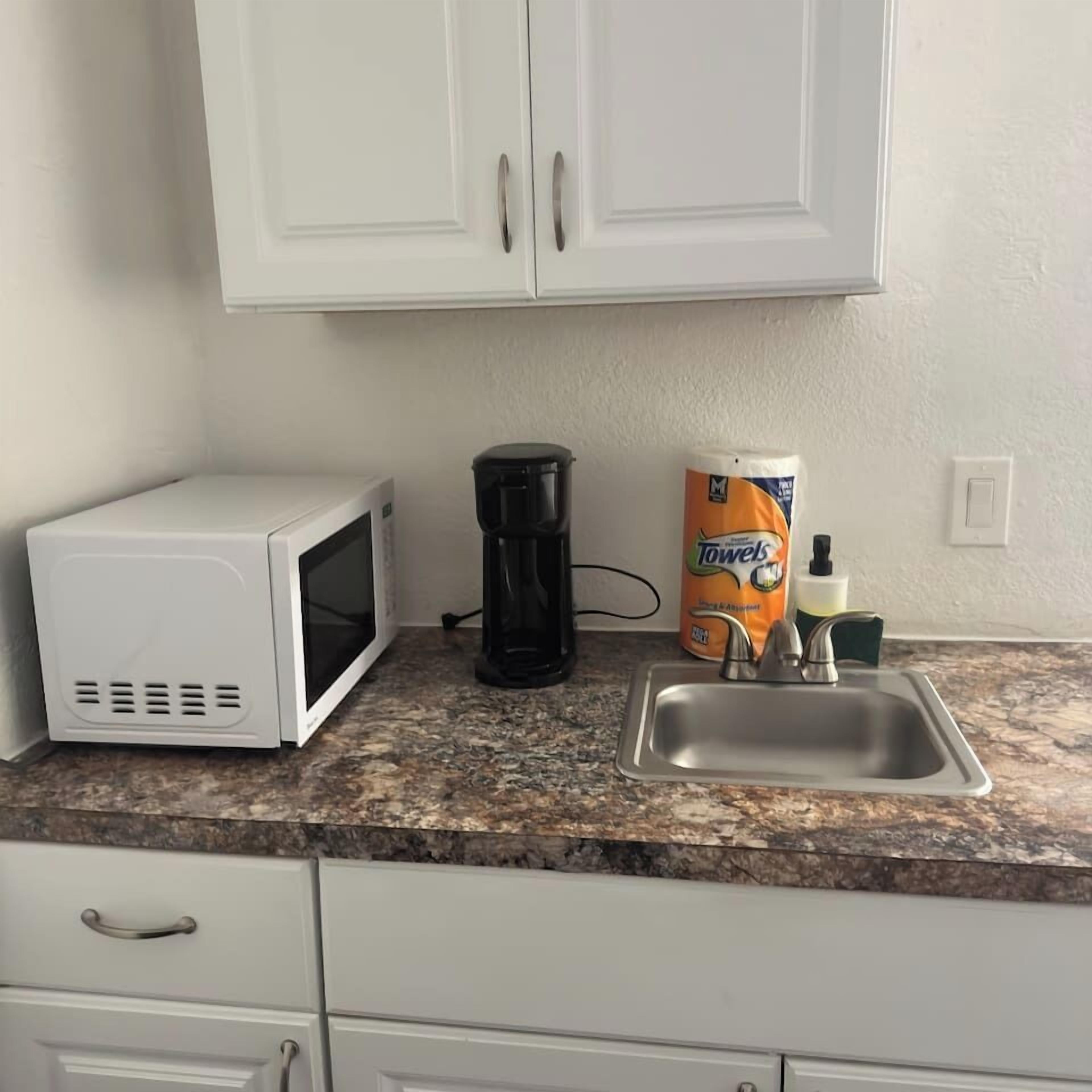 Microwave, coffee/tea maker, dining tables
