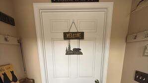 A door with a 'Welcome to the Cabin' sign, a 'Welcome' sign, and a bear-themed decoration. - Cozy Newly Renovated 3BR Madison Condo Pool + Tennis White Mountains Getaway (Conway)