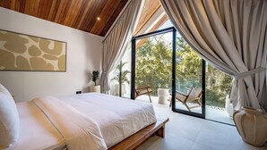 A bedroom with a large bed, a wooden ceiling, and a balcony with a view. - Uluwatu Surf Sanctuary Villa (Uluwatu)