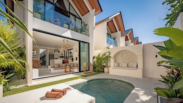 A modern house with a swimming pool, a dining area, and a living room with a large window. - Uluwatu Surf Sanctuary Villa (Uluwatu)