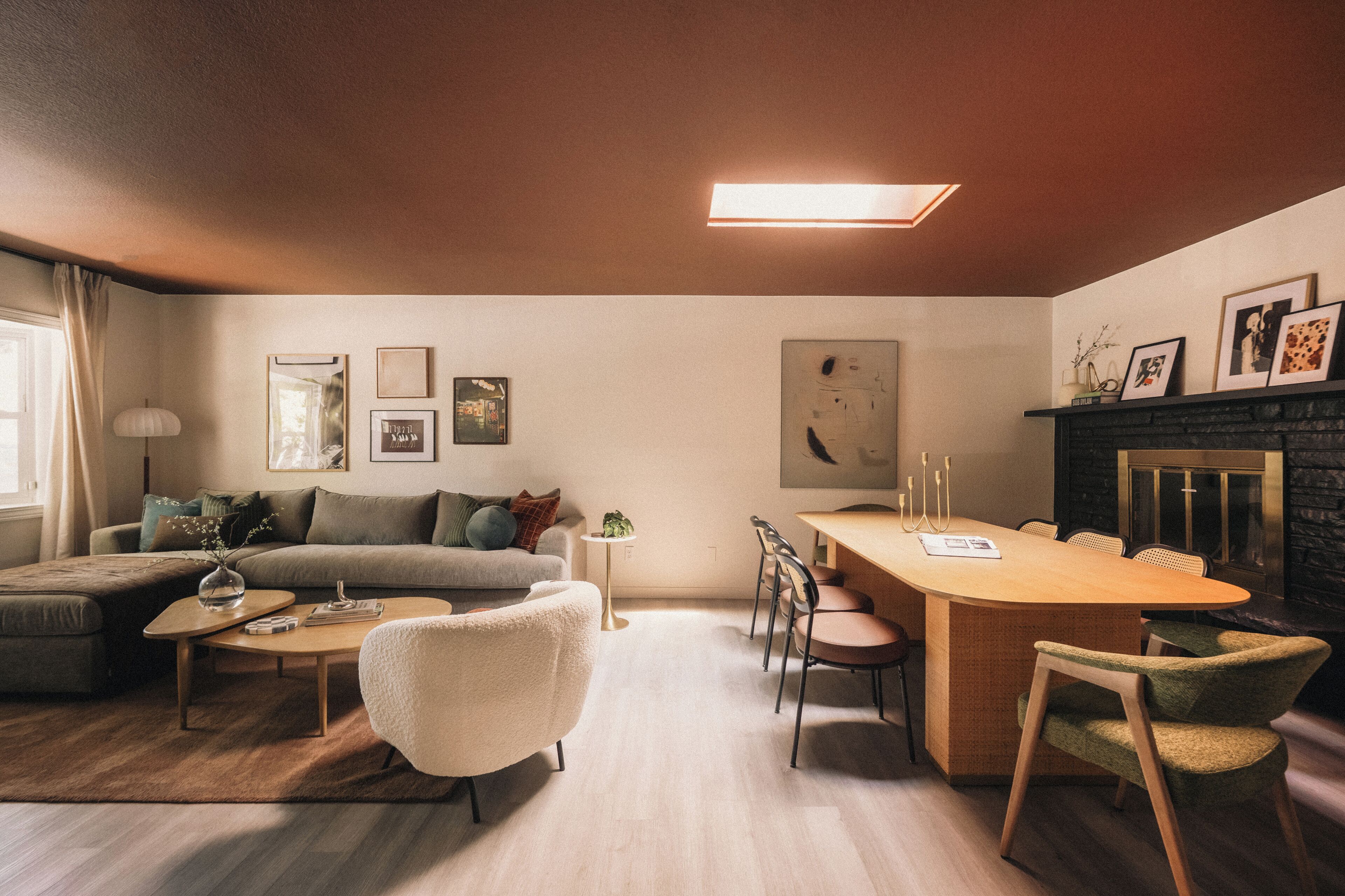 A modern living room with a sofa, coffee table, and dining area.