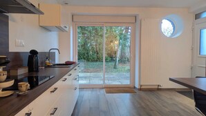 Een moderne keuken met een schuifdeur naar een tuin.