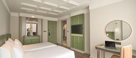 Una habitación de hotel con una cama grande, un escritorio con silla, un televisor y un espejo.
