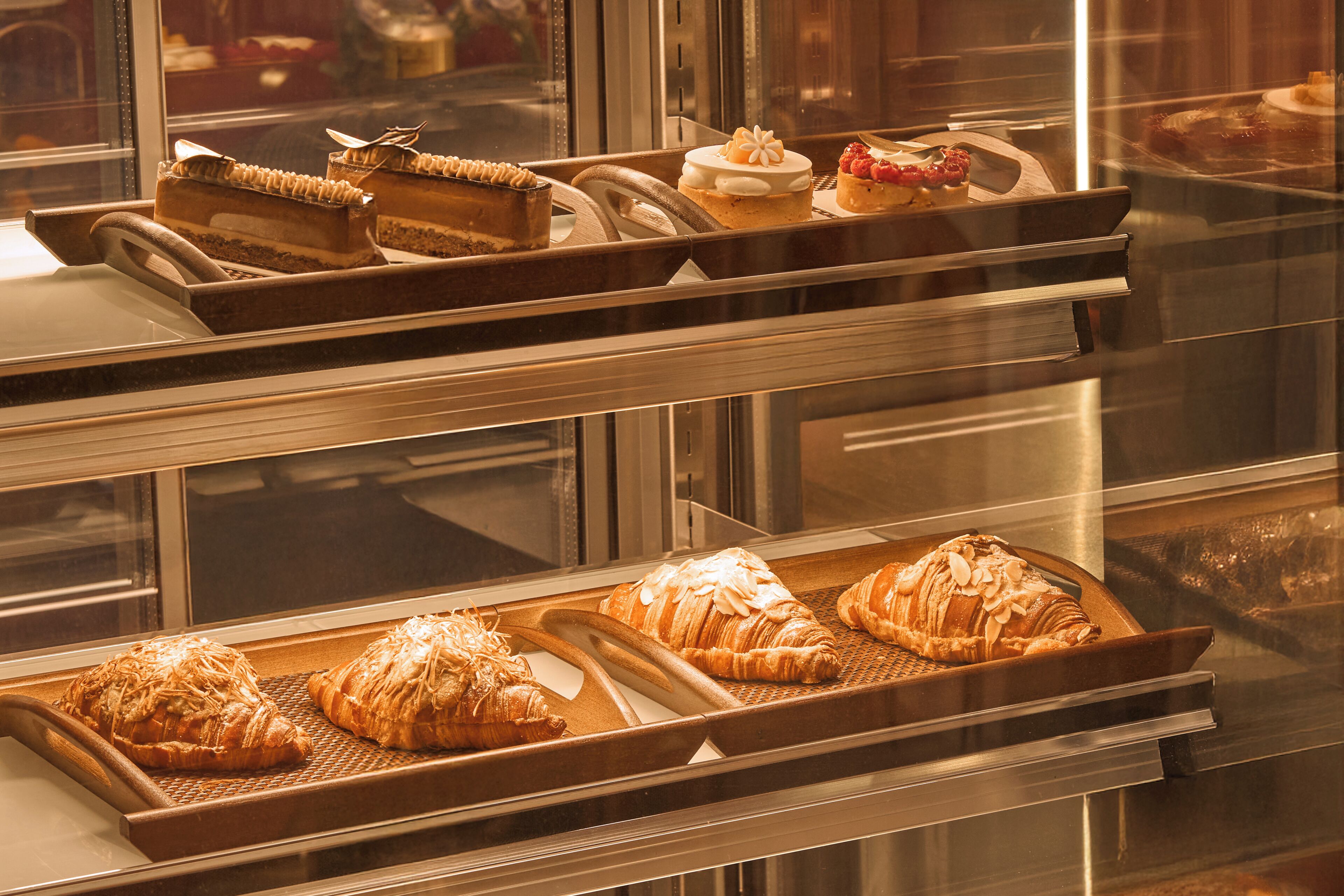 A bakery display case with various pastries and desserts.