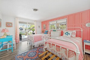 A bedroom with two beds, a window, and a view of the outdoors. - Coastal Retreat with Private Pool on Manasota Key (Englewood)