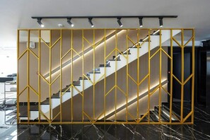 A staircase with a geometric patterned railing and a modern design.