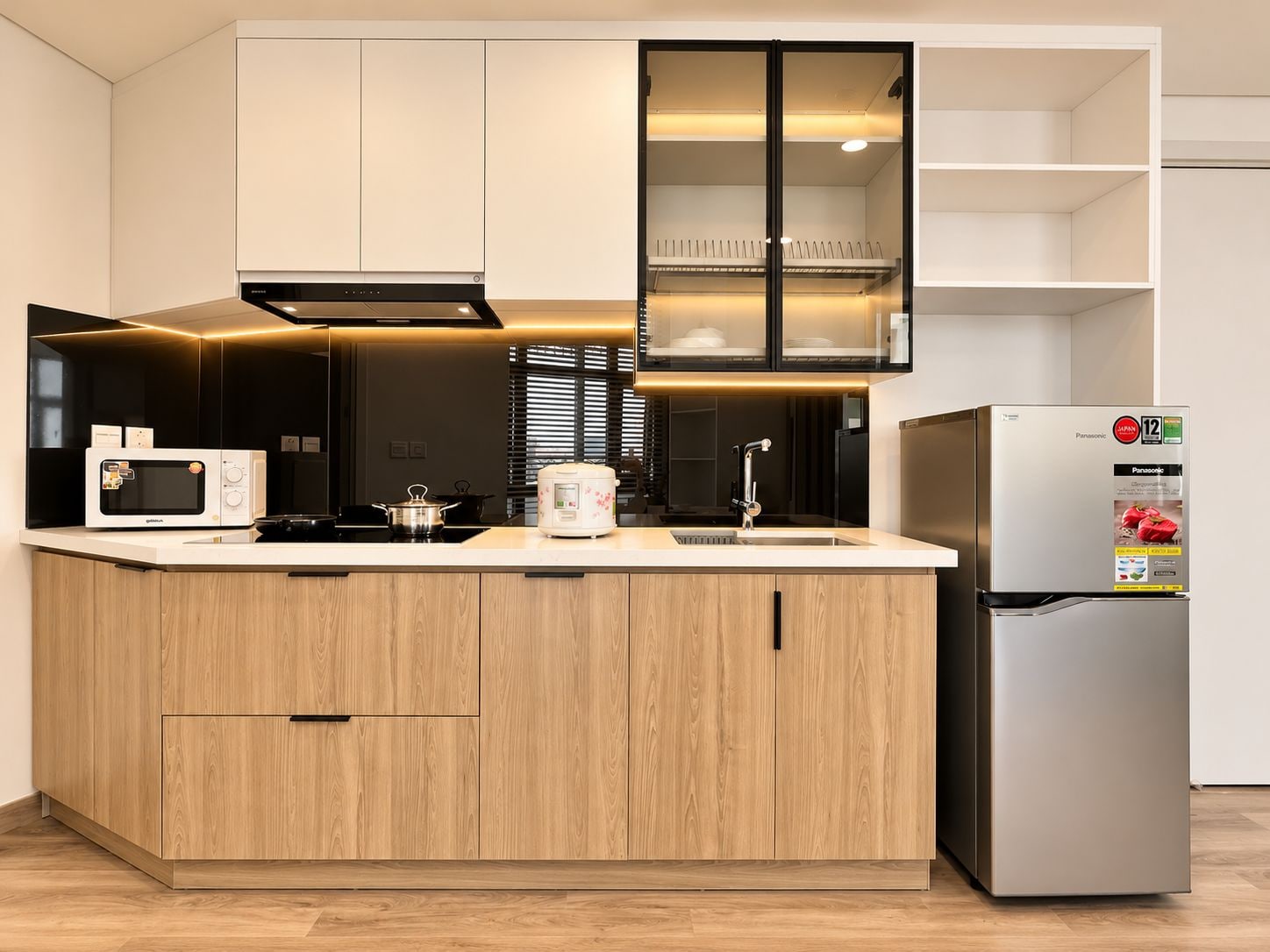 A modern kitchen with a built-in microwave, stove, and refrigerator.
