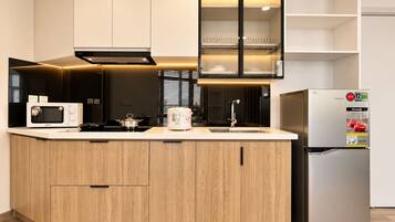 A modern kitchen with a built-in microwave, stove, and refrigerator.
