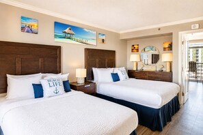 A hotel room with two beds, a balcony, and artwork on the walls. - Cozy 1BR Oceanview Condo! Caravelle 1101 (Myrtle Beach)