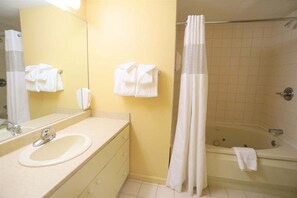 A bathroom with a sink, mirror, towel rack, and bathtub. - Pollard Brook 2 Bedroom Condo in Lincoln (Lincoln)