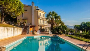 A pool area with a clear view of the pool, a staircase leading to a building, and surrounding greenery. - Beautiful home in Agropoli (Agropoli)