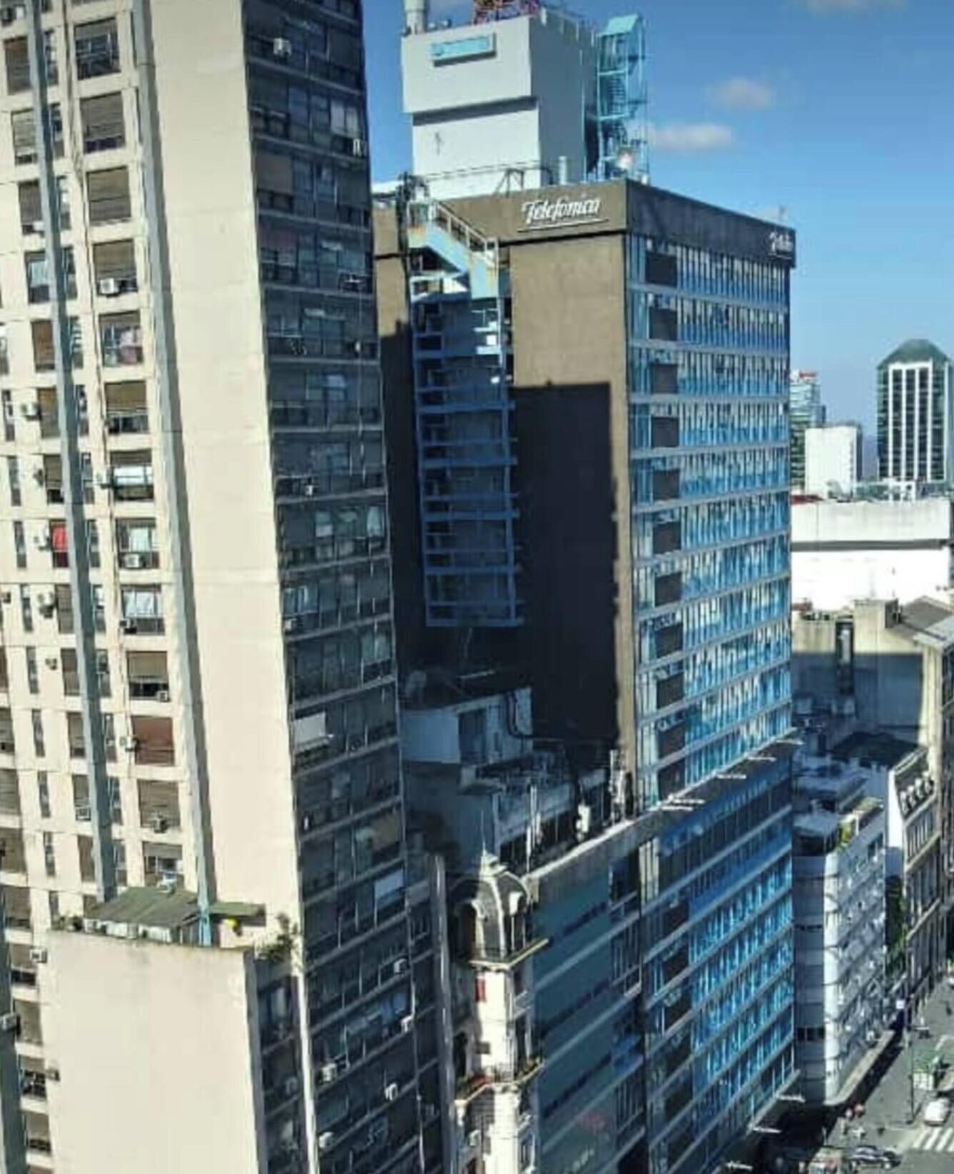 A high-rise building with multiple floors, a prominent sign reading 'Telefunken,' and a clear view of the surrounding urban skyline.