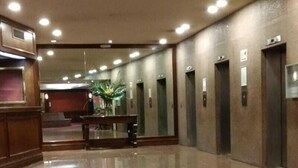 A spacious lobby with a polished floor, a reception desk, and multiple elevators. - Studio in the sky: Obelisco - Av Corrientes. Microcentro CABA. Argentina. (Buenos Aires)