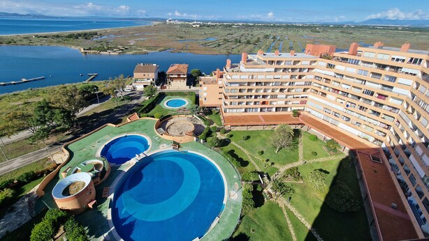 A resort with multiple swimming pools, a large building with balconies, and a view of the surrounding landscape. - TRAMUNTANA 325 STUDIO (Roses)