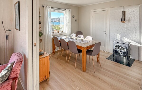 A dining area with a wooden table, chairs, and a vintage stove.