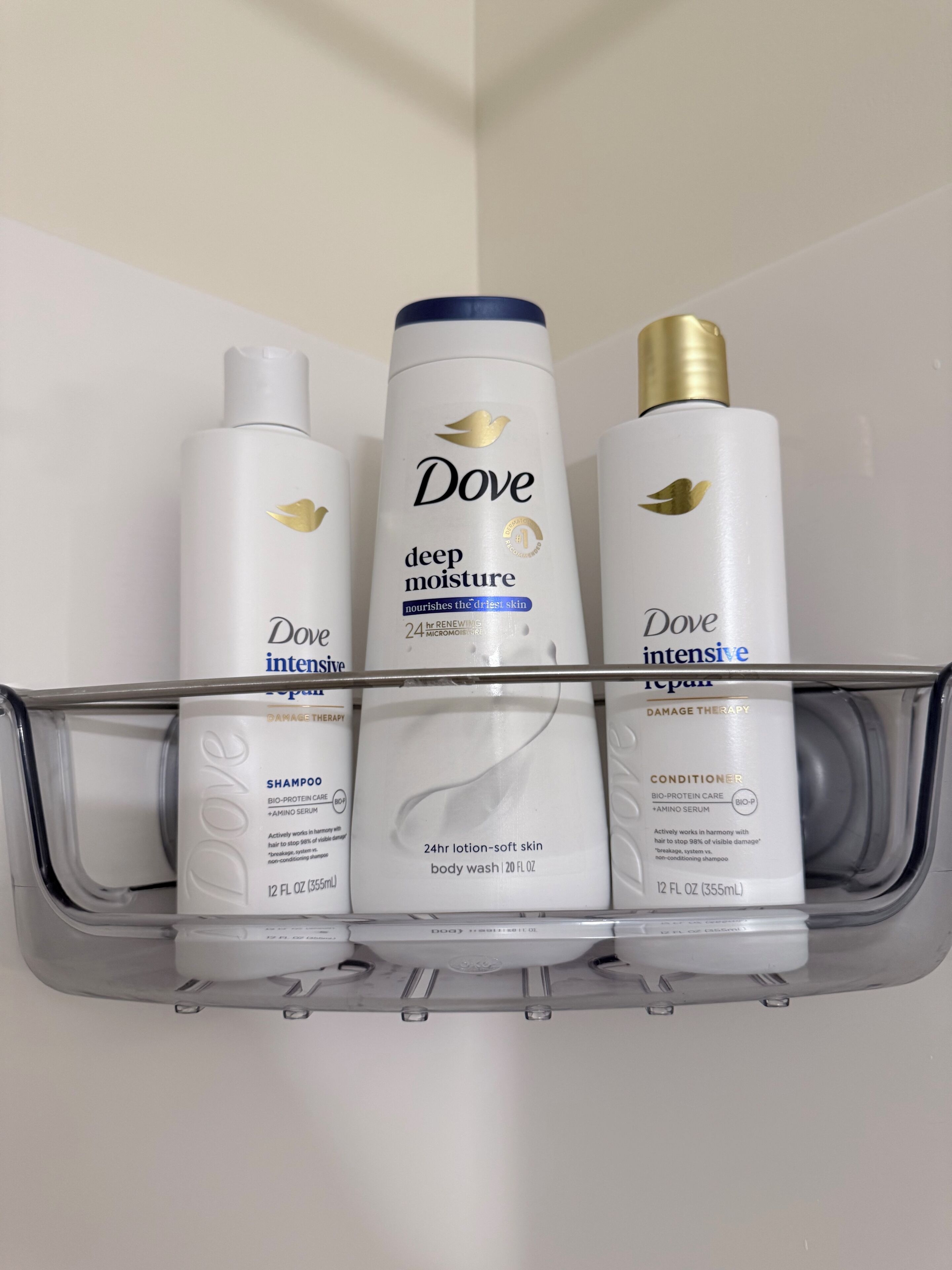 A bathroom shelf with Dove skincare products including deep moisture lotion, intensive repair, and conditioner.