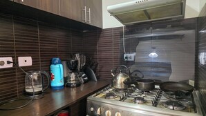 A kitchen with a gas stove, a kettle, a blender, and a coffee maker. - Upscale 3BR Apt in Cusco,Gateway to Machu Picchu , Best Area (Cusco)