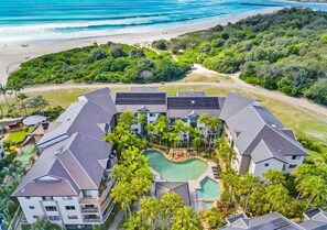A resort with a central pool, multiple buildings, and a beach view. - Azure by Khove - Palm Beach (Palm Beach)