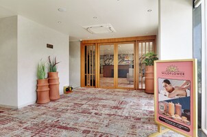Un vestíbulo de hotel con alfombra estampada, un letrero de 'No fumar' y un letrero de 'Comfort Inn'.