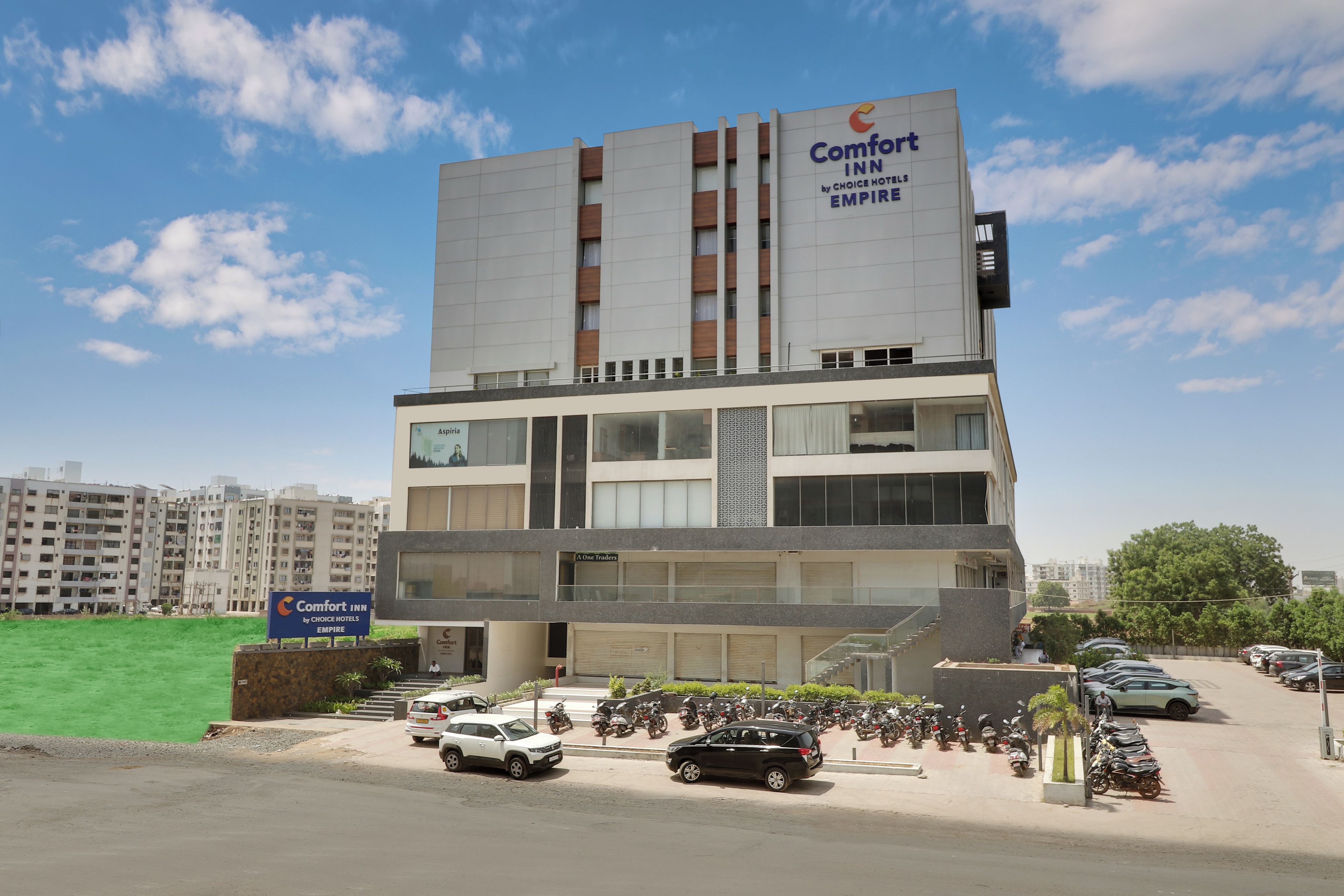 A multi-story hotel with a prominent sign for Comfort Inn by Choice Hotels Empire.