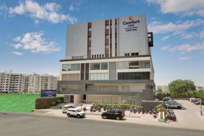 A multi-story hotel with a prominent sign for Comfort Inn by Choice Hotels Empire. - Comfort INN Empire Morbi (Morbi)
