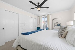A bedroom with a bed, a ceiling fan, a desk, and a chair. - South Mission Beach Home – 3BR, Epic Patio, Rare 3-Car Parking, Steps to the Sand (San Diego)