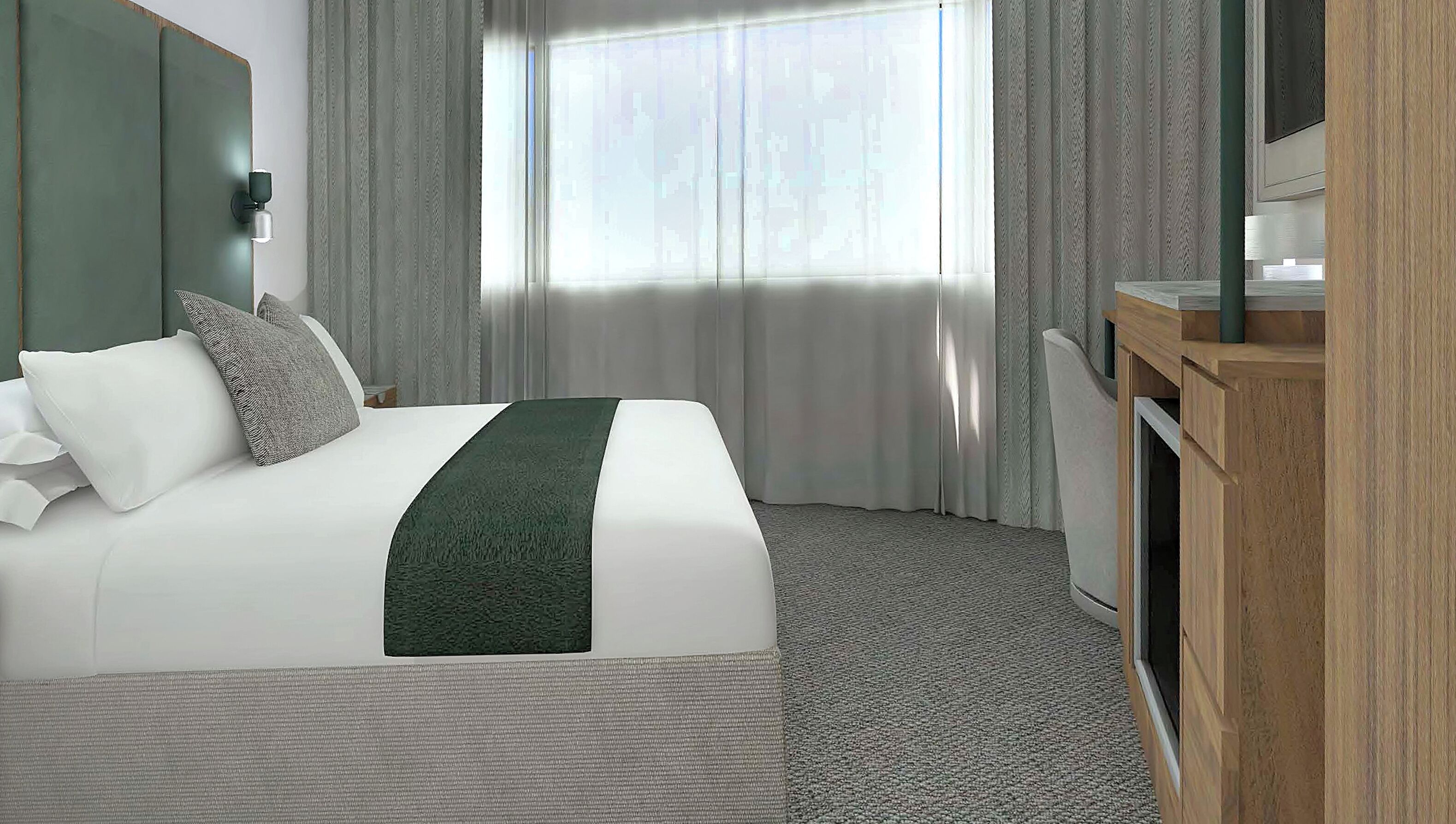 A hotel room with a bed, a television, a desk, and a window with curtains.