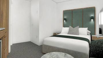 A hotel room with a bed, bedside tables, a desk, and a mirror.