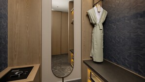 A modern bathroom with a wooden vanity, a robe hanging on a rack, and a mirror. - ChangZhou DaJiuDian (Changzhou)