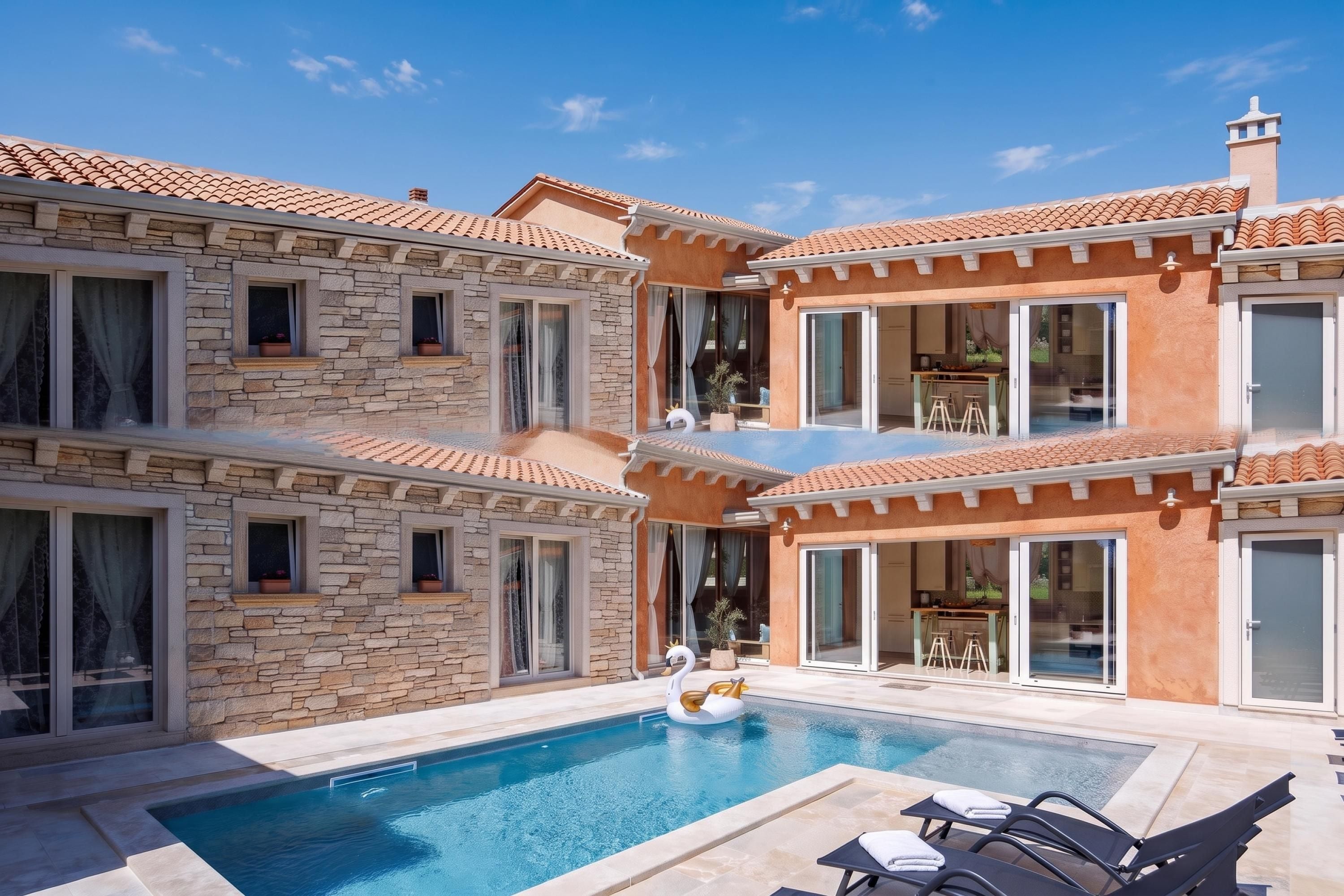 Un edificio de varios pisos con piscina, fachada de piedra y balcones.