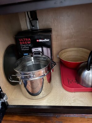 A kitchen with a thermal coffee maker, a stainless steel pot, and a red pot on the counter. - Unbeatable location, Multiple beds (San Diego)