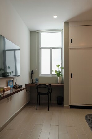 A room with a desk, chair, window, and a door. - Modern Loft w/Pool & Parking Near Zona Dorada Beach (Mazatlán)