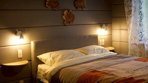 A bed with white linens, two bedside lamps, and wall-mounted decor. - MATRYOSHKA HOUSE (Yoichigun)